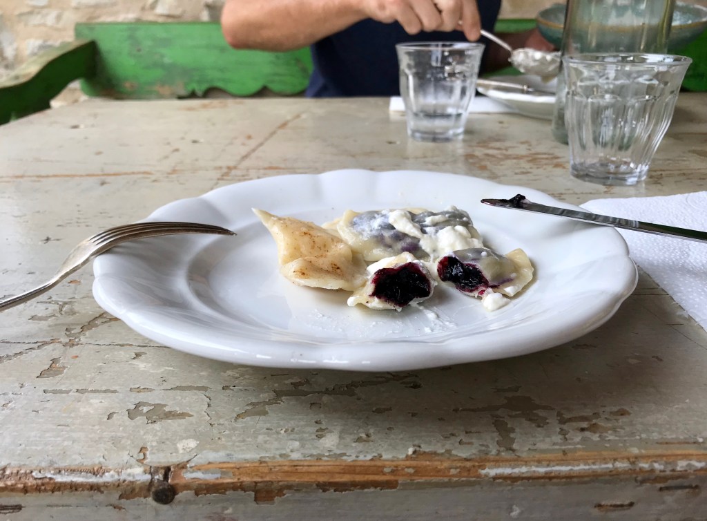 Pierogi dumplings with bilberries and cream
