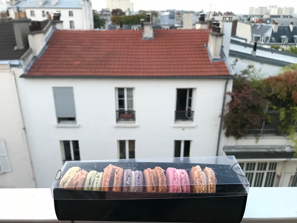 Colourful cookies in a box with a city view  