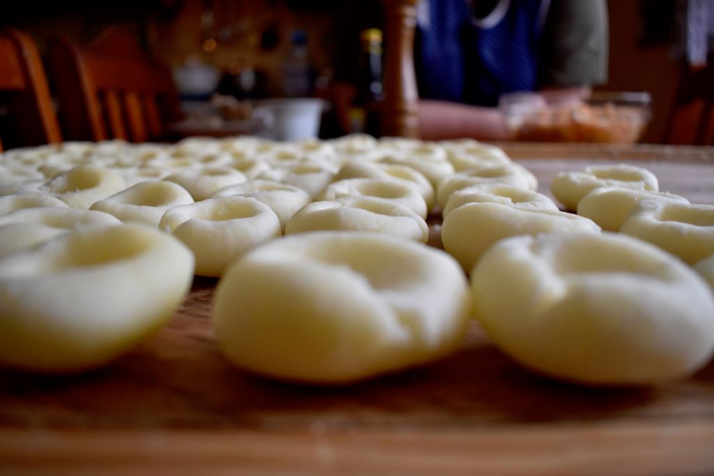 Dumplings lined on a pastry board 