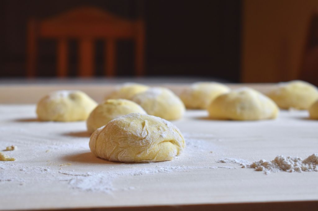 Buns proofing on a floured pastry board 