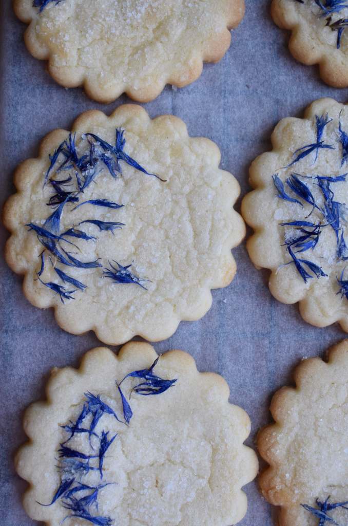 round shortbread biscuits with blue cornflower petals