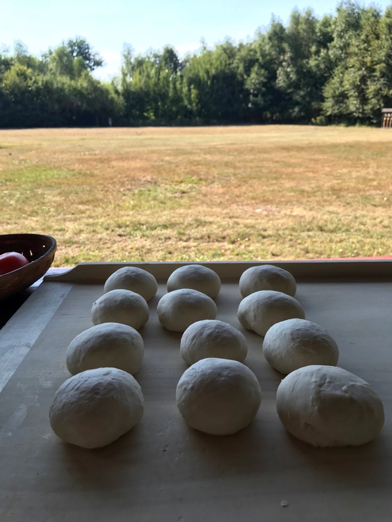 pieces of dough resting on a pastry board outdoors 